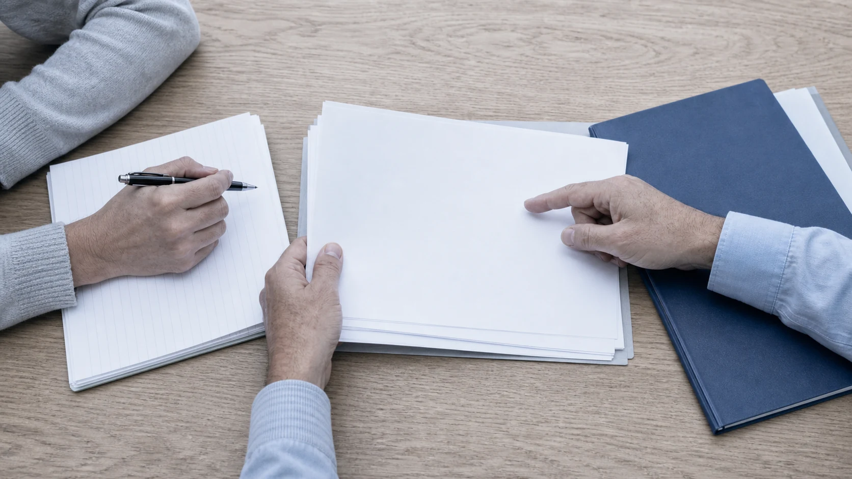 A nonprofit leader and advisor reviewing paperwork across a table